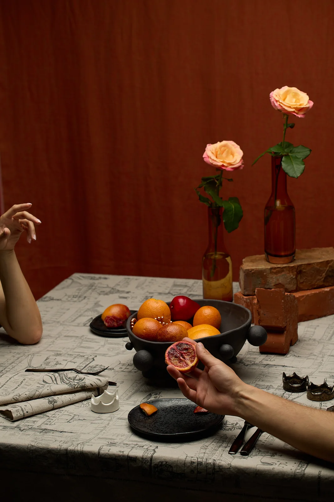 A table laid with the “Royal Vilnius Love Story” tablecloth, fruit and roses