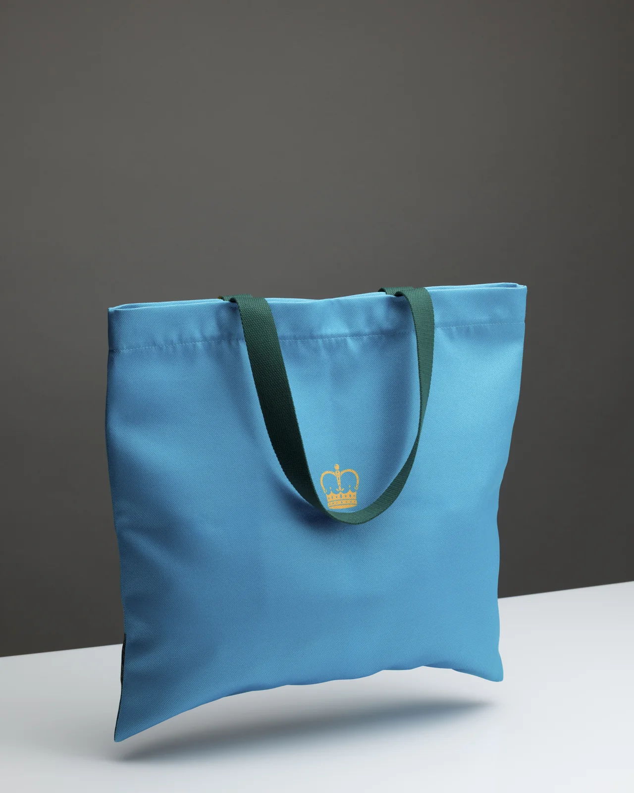 Back of the blue “Queen Catherine” shopping bag with a small gold-coloured crown mark