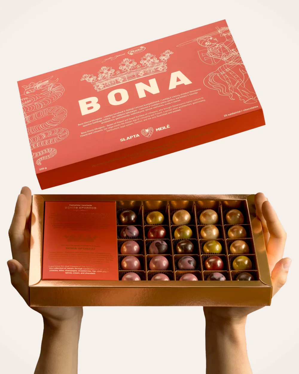 Hands holding an open “Bona” sweets set with colourful sweets, the lid above it