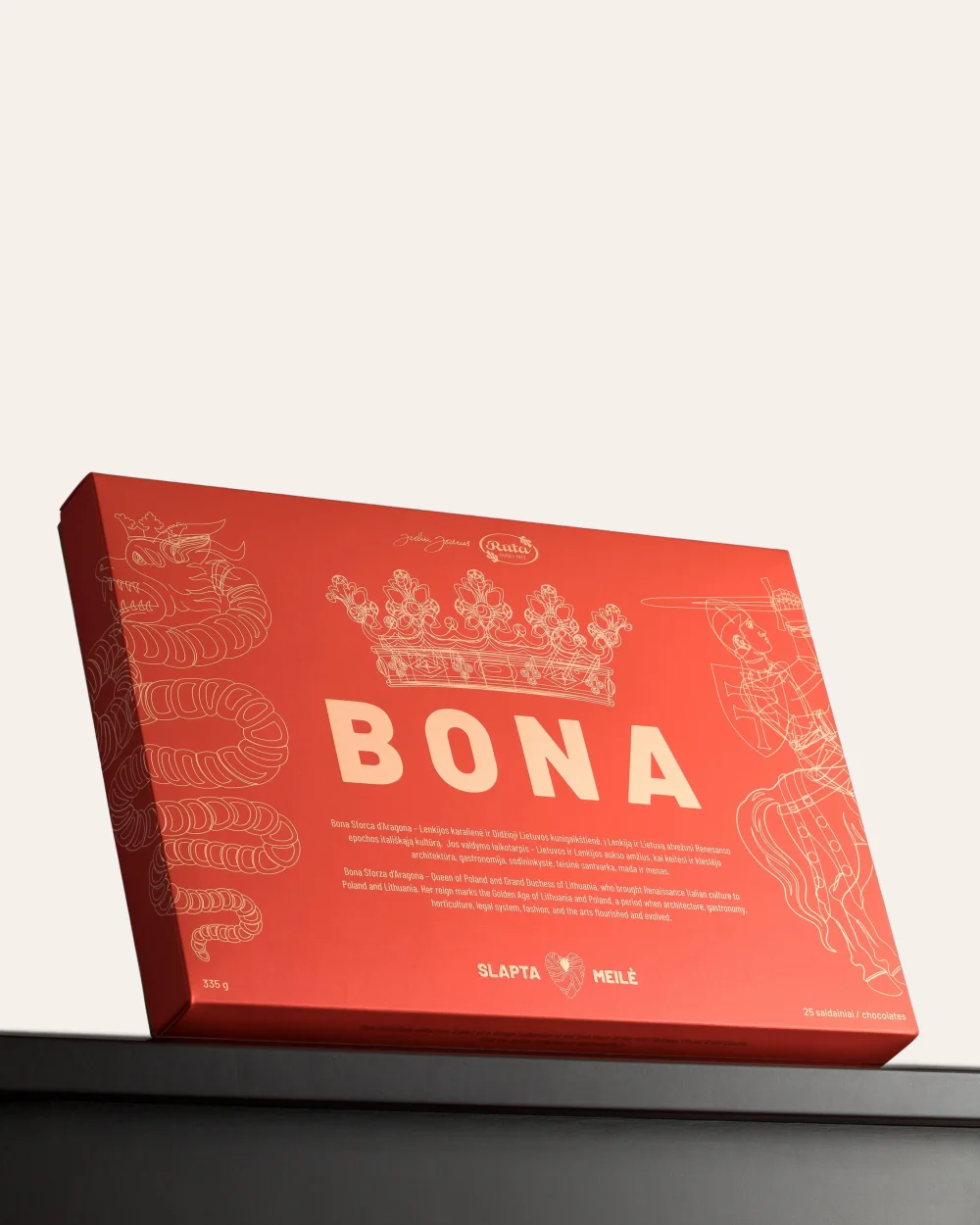 Red box of the “Bona” chocolate sweets set with a crown drawing on a black background