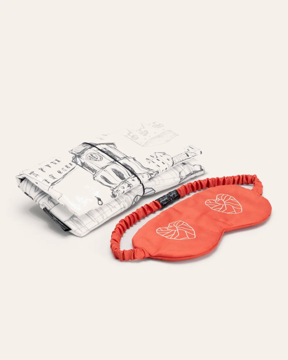 Red “Royal Vilnius Love Story” sleep mask and a white case with a drawing of Vilnius