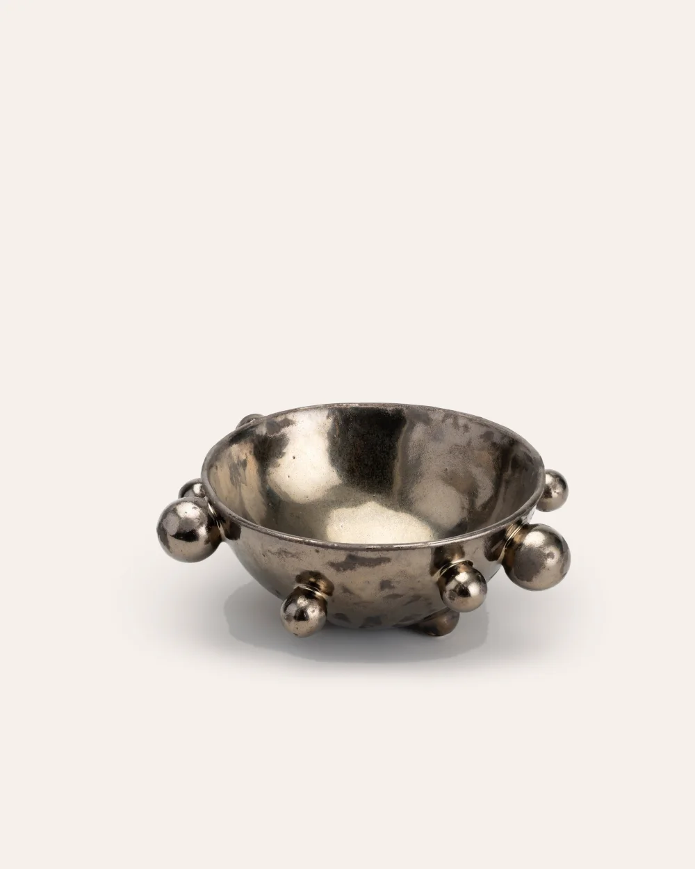 Medium dark gold “The Queen's Pearl Bowl” with beads on a light background