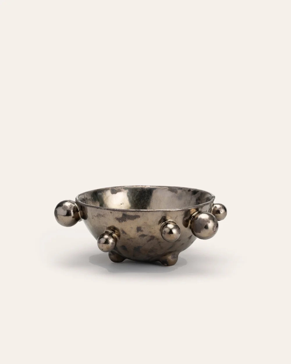 Medium dark gold “The Queen's Pearl Bowl” from the side, distant view