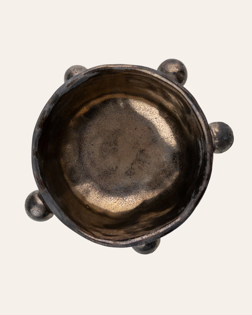 Small dark gold “The Queen's Pearl Bowl” from above, showing the glossy inside