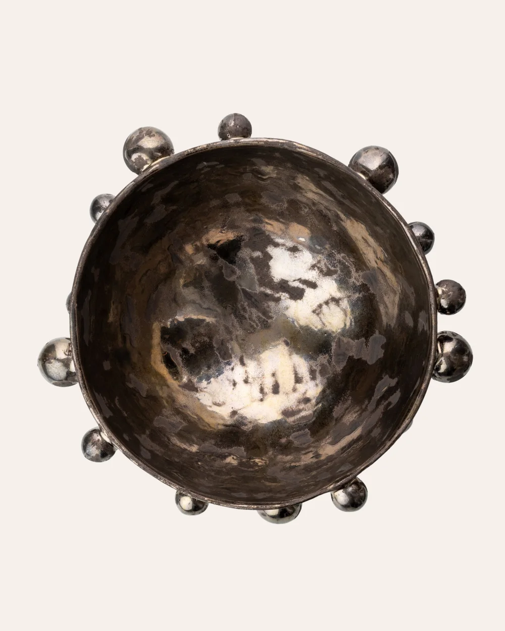 Large dark gold “The Queen's Pearl Bowl” from above with little balls around the rim