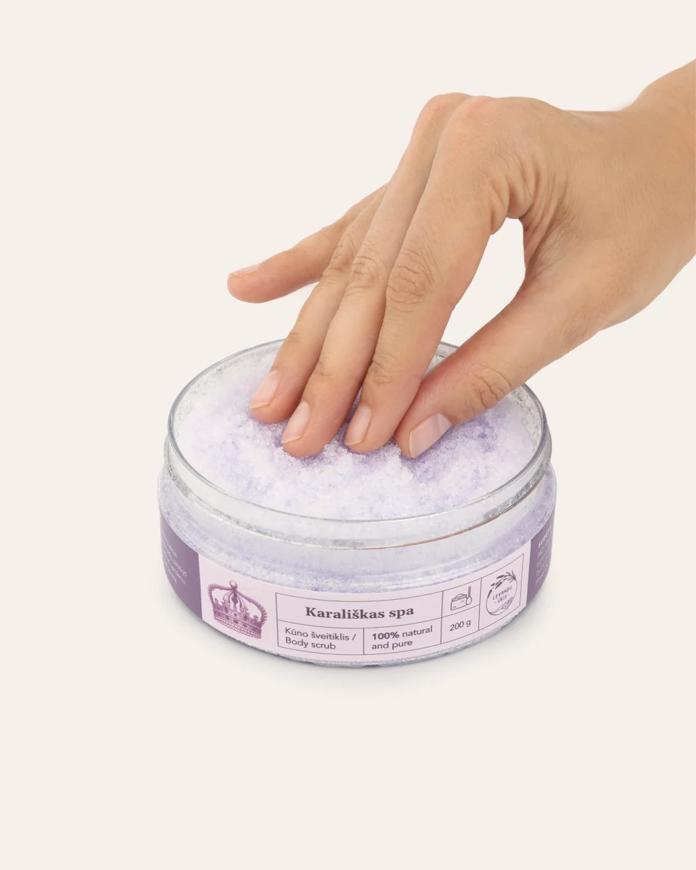 Otwarty lawendowy peeling do ciała „Królewskie SPA” z białymi kryształkami soli, dotykany dłonią