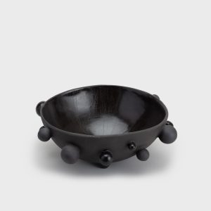 Large matte black “The Queen's Pearl Bowl” with ball feet on a light background