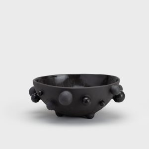Large matte black “The Queen's Pearl Bowl” from the side, seen from a distance