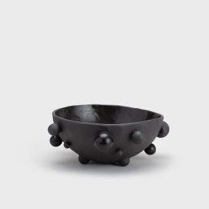 Medium matte black “The Queen's Pearl Bowl” from the side, distant view