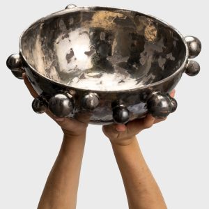 Large dark gold “The Queen's Pearl Bowl” raised in hands, glossy inside visible