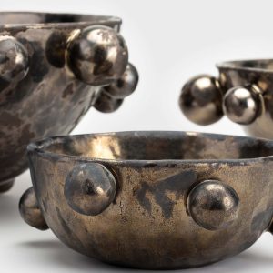 Close-up of the glaze and beads of dark gold “The Queen's Pearl Bowl” bowls