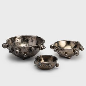 Three dark gold “The Queen's Pearl Bowl” bowls in different sizes on a light background
