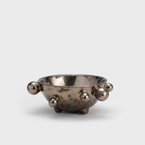 Medium dark gold “The Queen's Pearl Bowl” from the side, distant view
