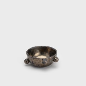Small dark gold “The Queen's Pearl Bowl” with balls on a light background