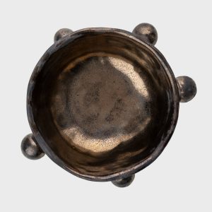 Small dark gold “The Queen's Pearl Bowl” from above, showing the glossy inside