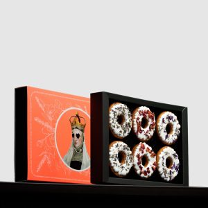 Orange box of “Queen Barbara's” gingerbread with Barbara's portrait and an open box of gingerbread