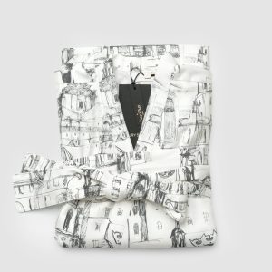 A folded white “Royal Vilnius Love Story” satin kimono robe with a label