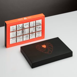 Orange box of decorated “Royal Vilnius” gingerbread and a closed black box with a heart