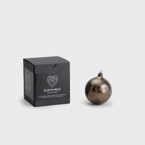 Dark gold “Pearl of the Vilnius Crown” Christmas ornament next to a black “Slapta meilė” gift box