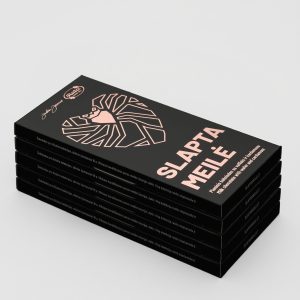 A pile of “Slapta meilė” milk chocolate packs with wafers and cardamom on a light background