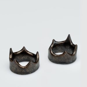 Two dark gold crown-shaped holders “Vilnius Crown” on a light background