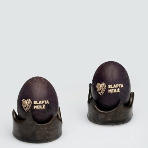 Dark gold “Vilnius Crown” holders with eggs inscribed “Slapta meilė”