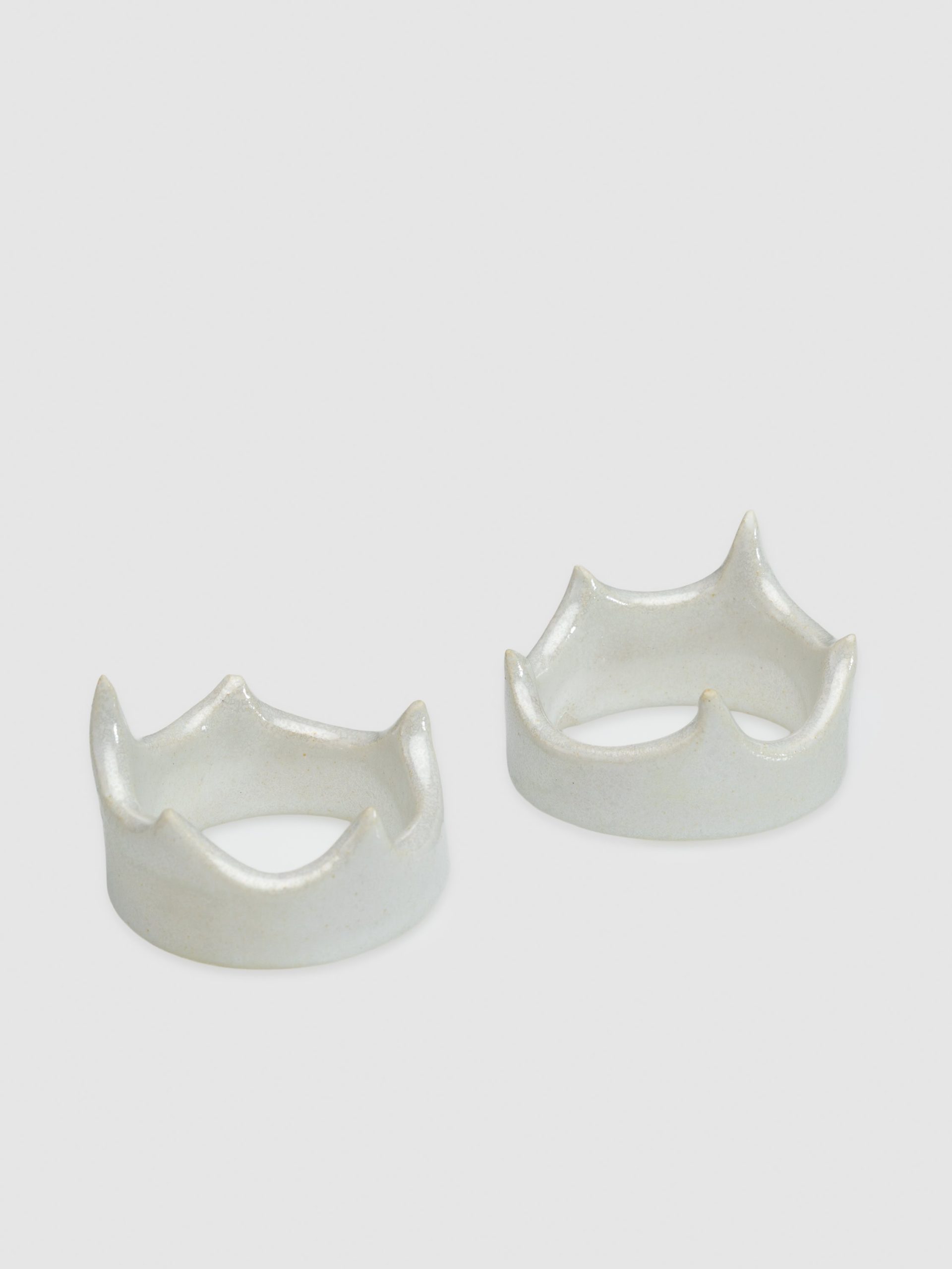 Two pearl crown-shaped holders “Vilnius Crown” on a light background