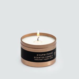 Lit small “Little Slapta meilė” candle in a copper-coloured tin with a black label on a light background
