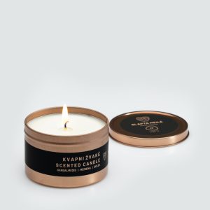 Lit “Little Slapta meilė” candle in a tin with the copper-coloured lid removed beside it