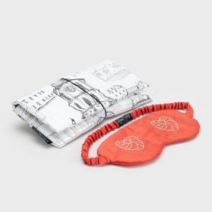 Red “Royal Vilnius Love Story” sleep mask and a white case with a drawing of Vilnius