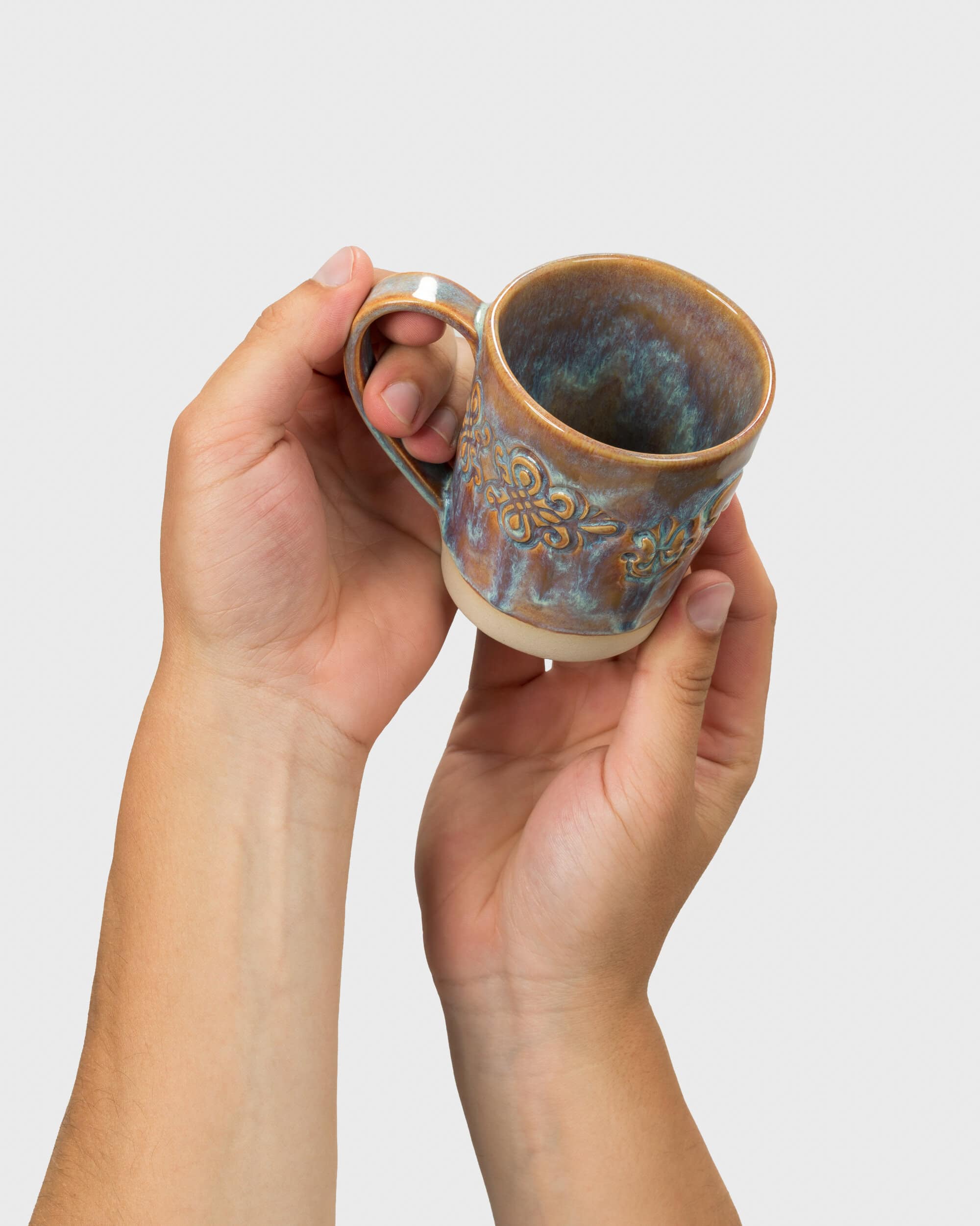 “Audience” mug tilted in hands, showing the bluish-brown glaze inside