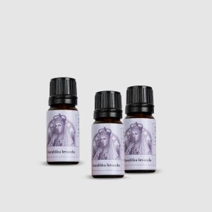 Three dark glass bottles of “Royal Lavender” lavender essential oil on a light background