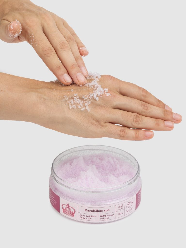 “Royal SPA” rose body scrub being applied to an arm, an open jar beside it