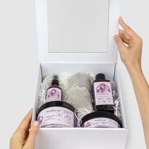 Open white gift box “Royal SPA” with lavender products, held in hands