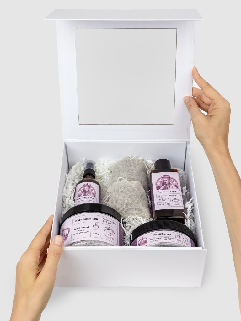 Open white gift box “Royal SPA” with lavender products, held in hands
