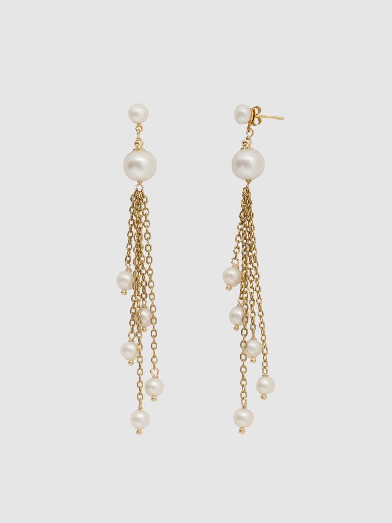 Gold earrings “The Queen's Spring” with pearls and dangling chains on a light background