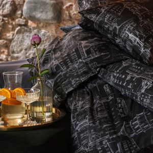 Anthracite satin bedding “Royal Vilnius Love Story” and a tray with drinks and a rose beside the bed