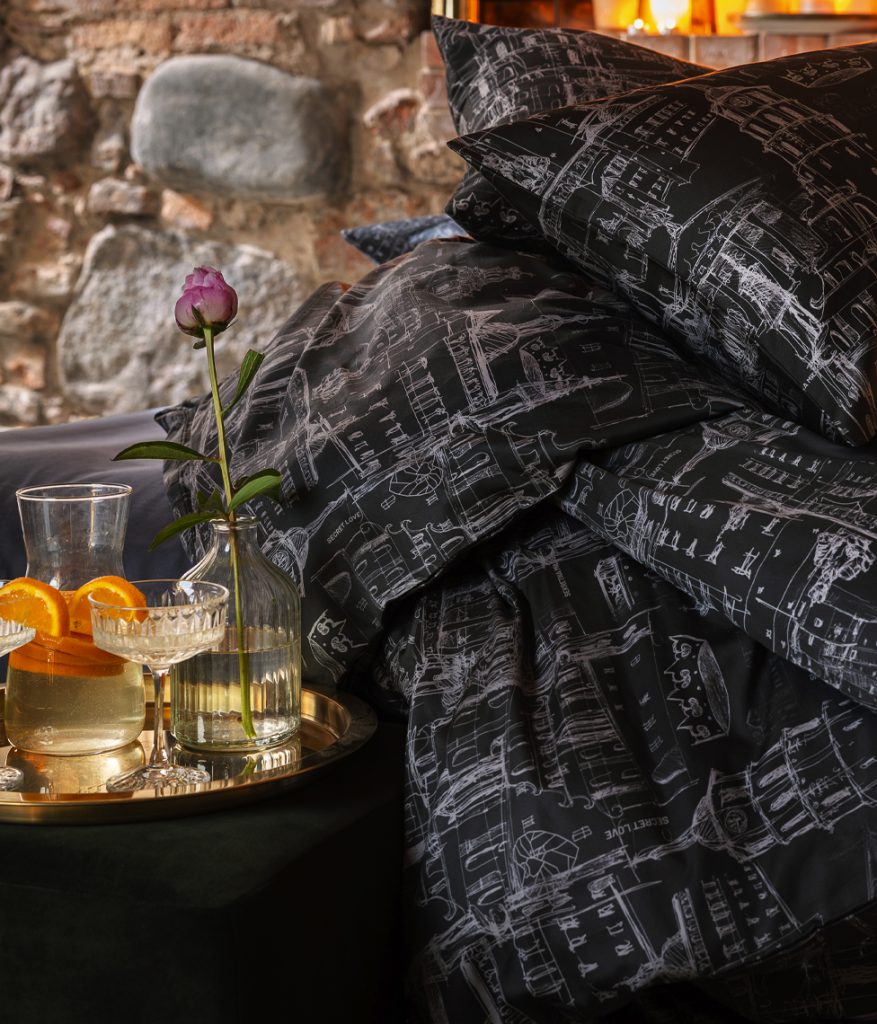 Anthracite satin bedding “Royal Vilnius Love Story” and a tray with drinks and a rose beside the bed