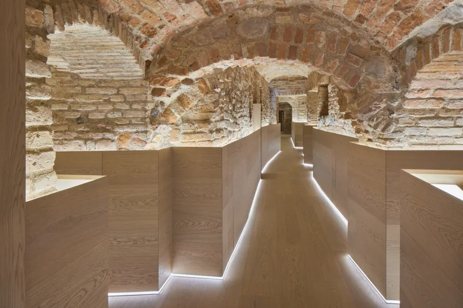 Lit path between brick vaults in a spa centre – “Queen Barbara's Pearls” treatment
