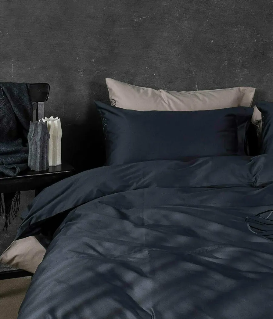 Anthracite satin pillowcases “Heart of Vilnius” on pillows in a bedroom
