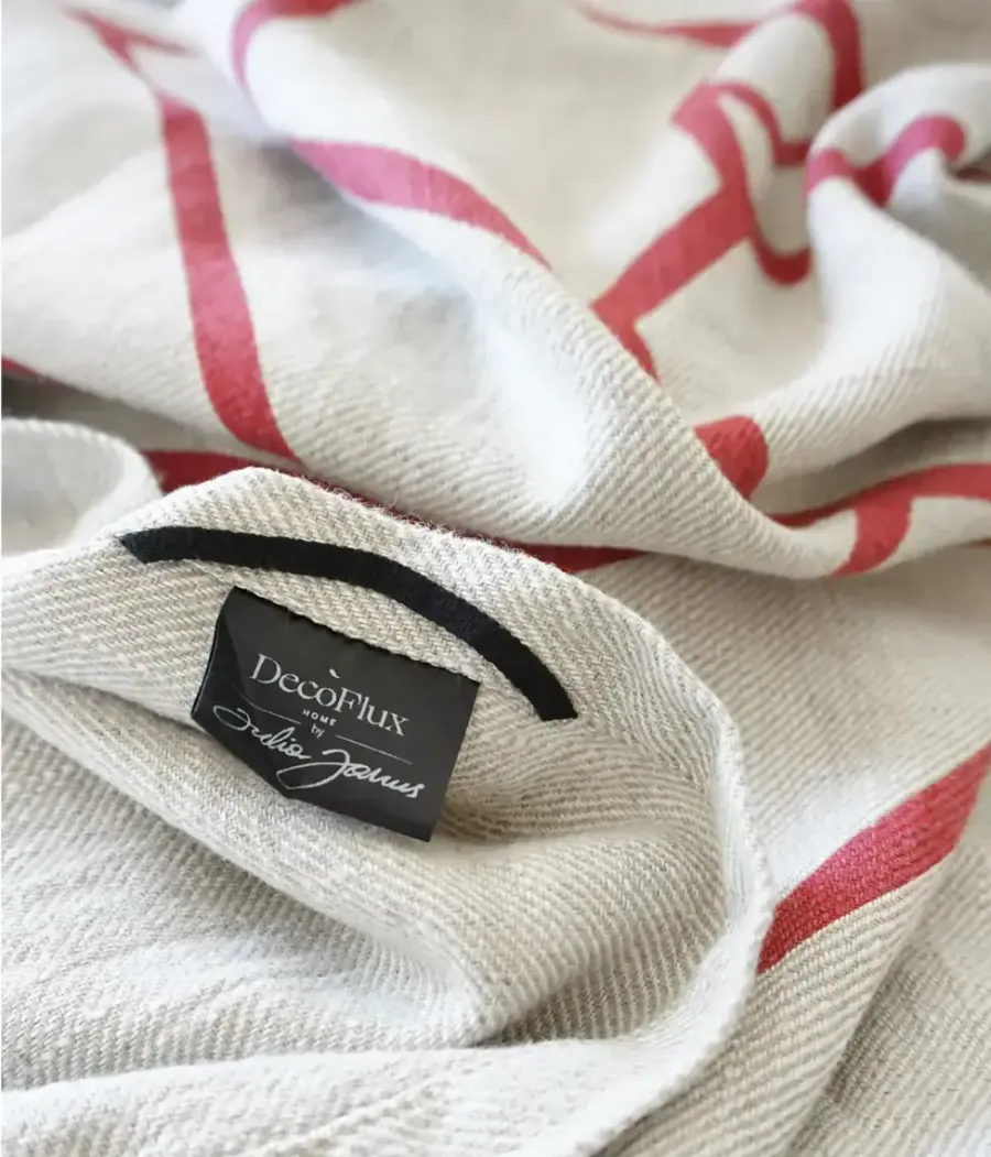 Close-up of “The King's” linen towel with red stripes and a “DecoFlux” label