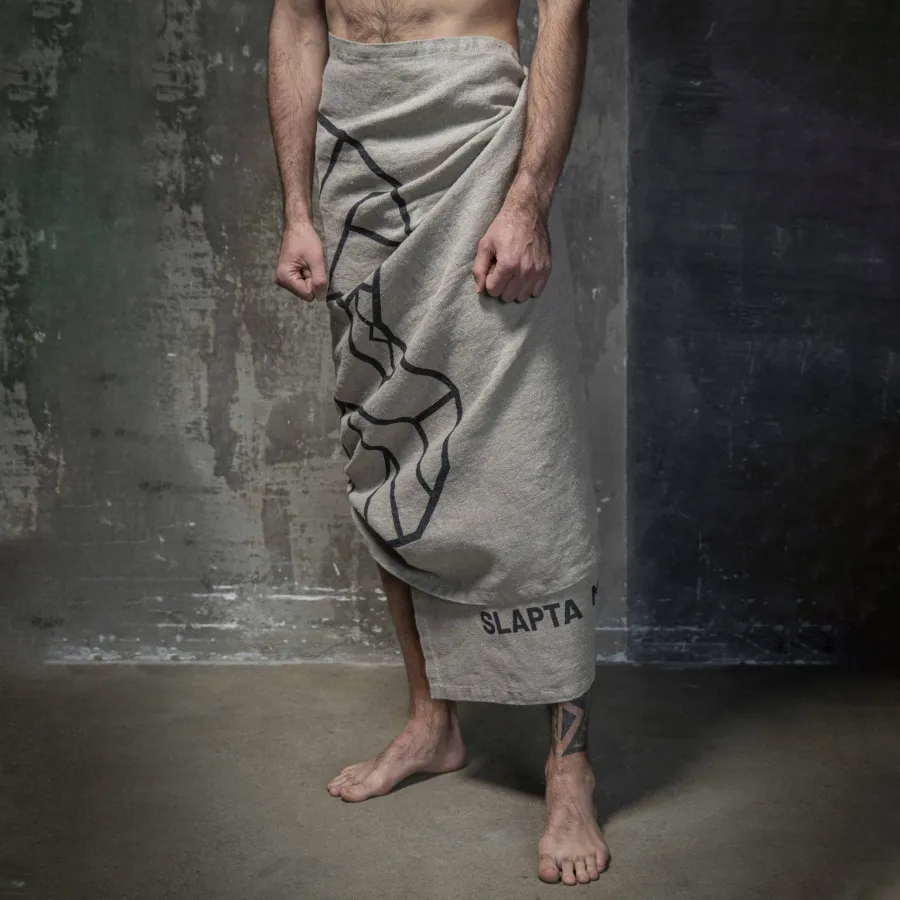Man wrapped in a grey “The King's” linen beach towel with a graphite drawing