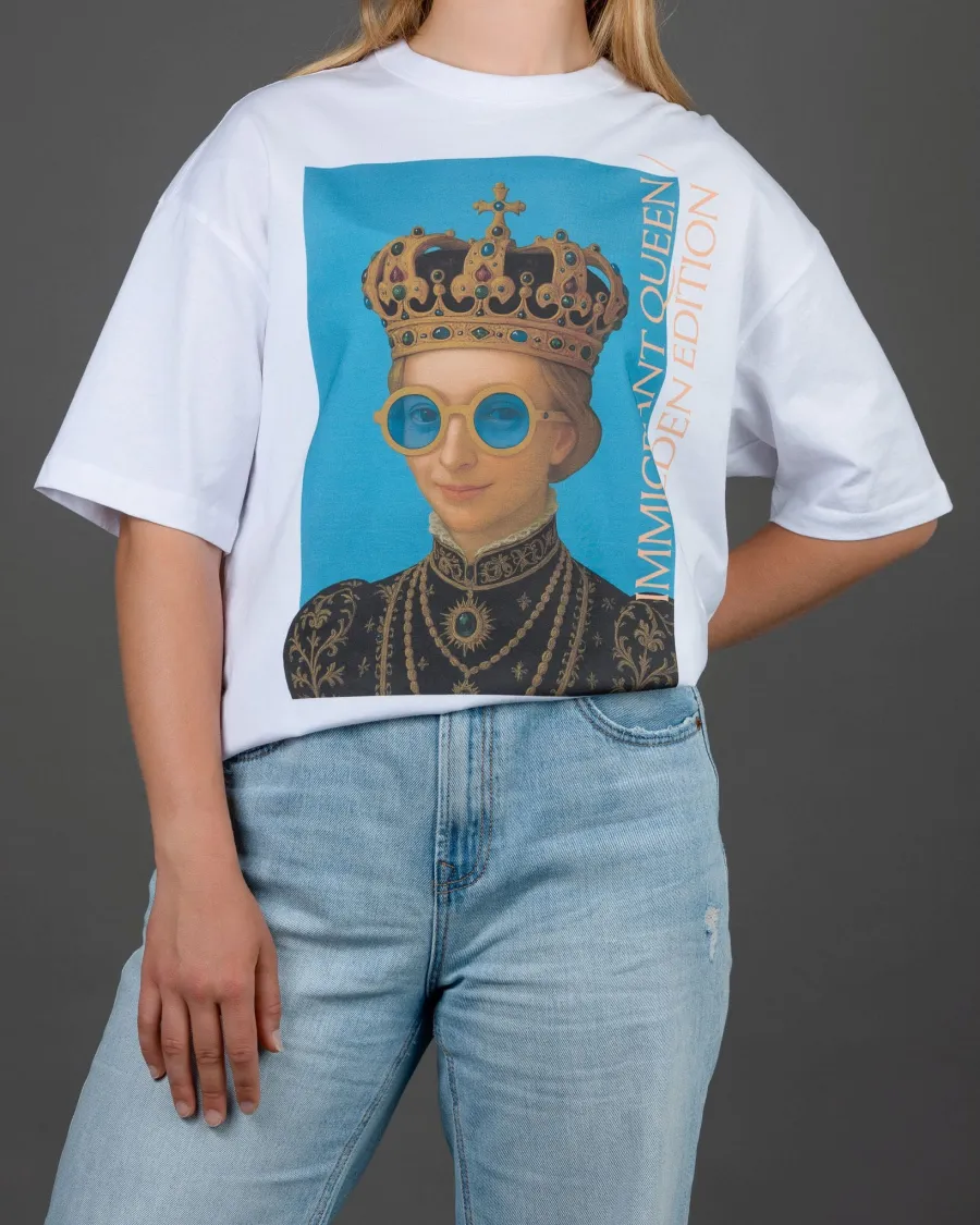 Woman in a white “IMIGRANT QUEEN / SWEDEN EDITION” T-shirt, hand behind her back