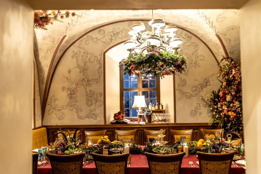 A vaulted restaurant hall with a long laid table – Vilnius Royal Hunt Dinner