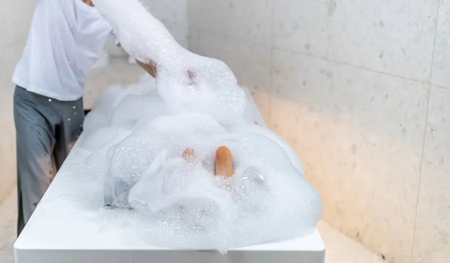 Feet immersed in white foam in a treatment room – “Queen Catherine's Spring” ritual