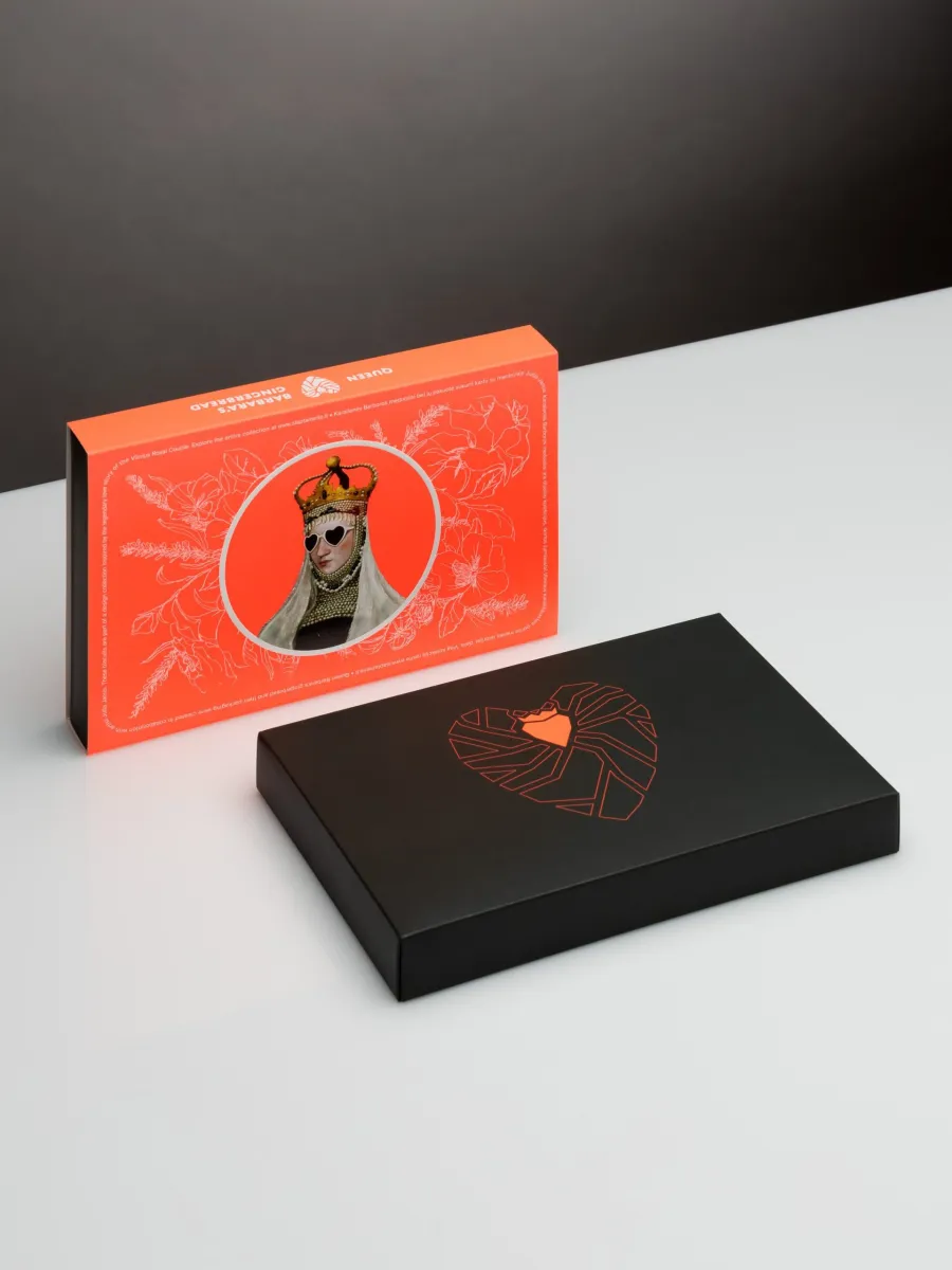 Orange box of “Queen Barbara's” gingerbread and a black box with a heart drawing on a table