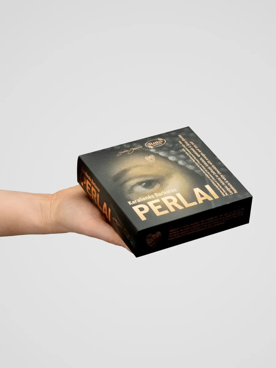 Box of “Queen Barbara's Pearls” with a painting of a woman's face, held in an outstretched hand