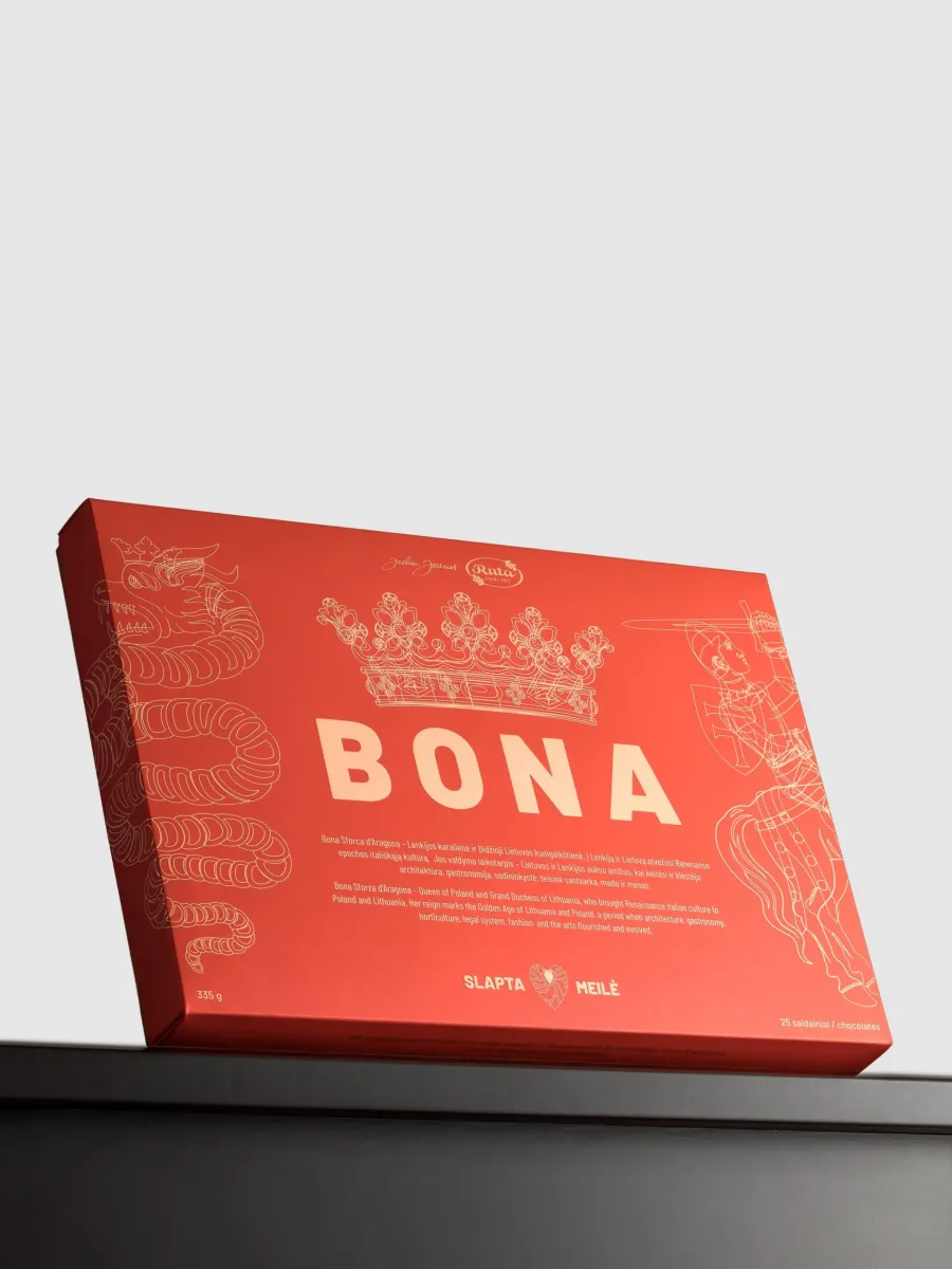 Red box of the “Bona” chocolate sweets set with a crown drawing on a black background