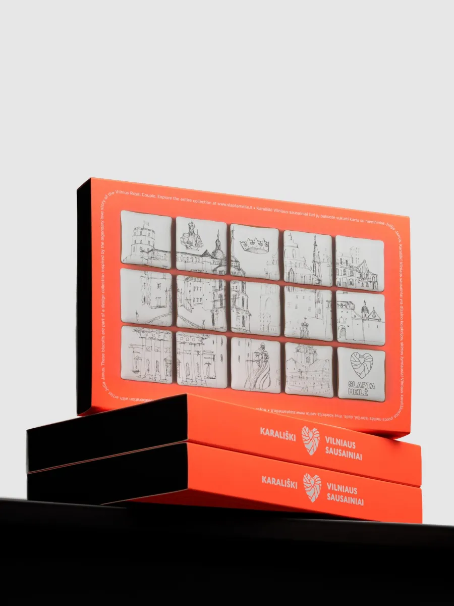 Orange boxes of “Royal Vilnius” gingerbread with Vilnius drawings on a black surface