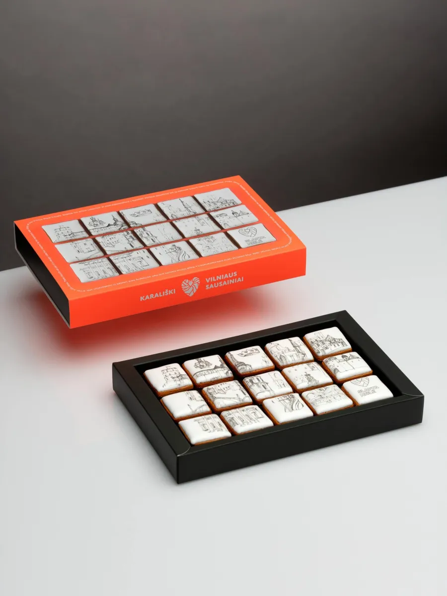 Orange and black boxes with fifteen square “Royal Vilnius” gingerbread biscuits on a table
